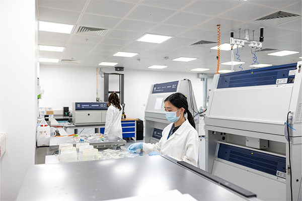 Two people working in a lab with high-tech equipment